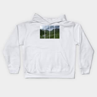 Wonderful landscapes in Norway. Vestland. Beautiful scenery of houses with grass roof. Norwegian traditional architecture Mountains, trees and snow in background. Cloudy day Kids Hoodie